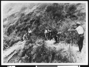 Men surveying on a hillside, ca.1930