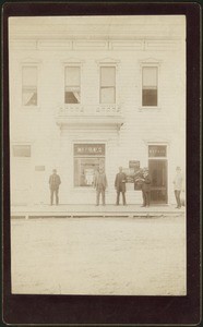 Five men standing in front of the W.E. Pile & Company building, 1900