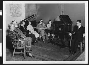 Group of blind people sitting around listening to a "talking book", ca.1928