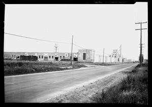 Exterior view of the Samson Rubber Company showing a water tower on the roof, Compton