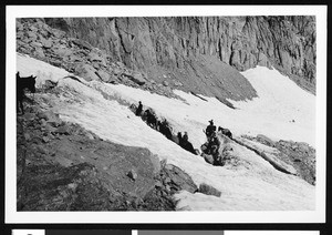 A horseback riding group in a rocky mountainous area, ca.1930