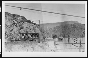 Construction of Boulder Dam, showing construction on the top of the dam, ca.1930