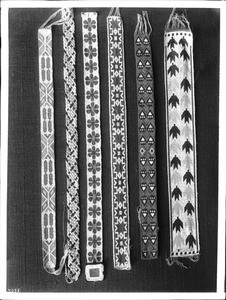 Collection of 6 pieces of Sioux Indian bead work (belts?) on display, ca.1900