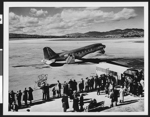 United Airlines commercial airliner, showing crowd in foreground, ca.1940