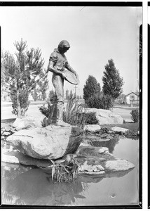 View of the reflecting pool featuring a statue of a gold miner outside the Circle Theater