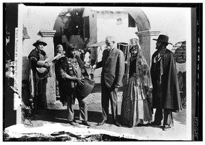 Frank Wiggins standing among actors at a motion picture studio