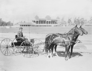 Captain Pierce of the Los Angeles Police Department on carriage with race horse team at the Agricultural Park Horse Show, 1895