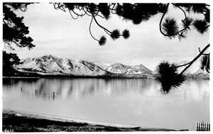 View of a lake with snow-covered mountains in the background