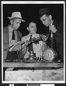 Three unidentified male employees at a factory, ca.1950