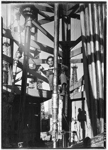 Man on a drill inside of an oil well