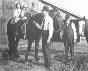 Children sitiing on horseback, ca.1900