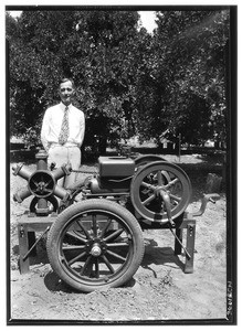 Man posing next to an aeroculator in Covina, ca.1930