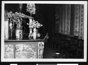 Interior view of a large room with ornate Chinese chairs along the wall, possibly a Chinese community room, ca.1920-1929