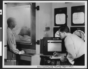 Scientists in a Lockheed Lab with an "environmental testing apparatus", ca.1940