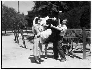 Man and a woman tending to an ostrich in Lincoln Park