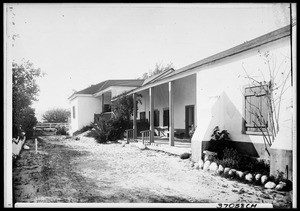 Dirt lane near an unidentified house