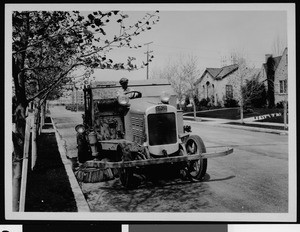 Department of Public Works employee operating a street sweeping vehicle