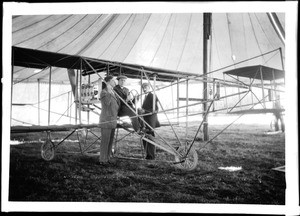 Aviators Glenn Curtiss, F.H. Johnson, and C.B. Harmon with a Curtiss biplane at the Dominguez Hills Air Meet, 1910