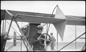 Aviator William Hoff behind the wheel of a biplane at the Dominguez Hills Air Meet, January 1912