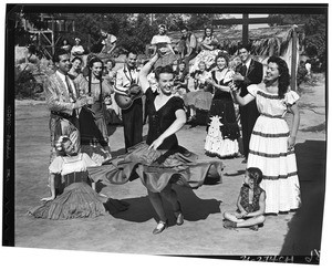 Woman dancing to guitar music as other people clap along