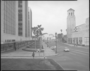 View of Wilshire Boulevard looking west from Mariposa Avenue, showing a woman crossing the street, ca.1953