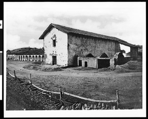 Mission San Miguel Arcangel from northeast side with tile fence, ca.1875