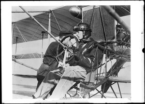 Pilot Glen Martin at the controls of his aircraft as a mechanic prepares the plane for takeoff at the Dominguez Hills Air Meet, 1912