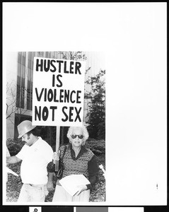 Portrait of an old woman holding a picket sign