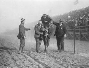 Portrait of aviator Arch Hoxsey lifted on his colleague's shoulders at the Dominguez Hill Air Meet, December 31, 1910