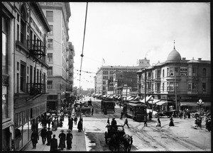 View looking down Broadway, south from 7th, and showing a variety of carts, streetcars and buildings, ca.1910