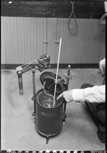 Man pointing at a thermometer in a metal container