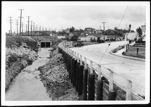 Venice Boulevard looking east from Lomita Street before the completion of the storm drain and the improvement of roadway, 1931