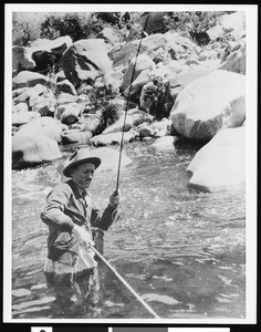 Trout fisherman fishing in a stream, ca.1930