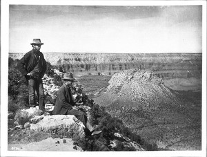 Two young men viewing Bass Camp and Mount We-tha-wa-lee, Grand Canyon, ca.1900-1930