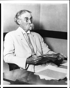 Portrait of Frank Wiggins seated at a desk