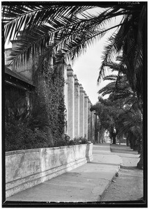 Exterior view of the San Gabriel Mission, showing a sidewalk, December 4, 1929