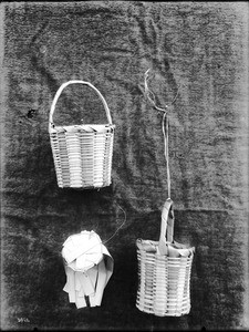 Three unidentified Indian baskets on display, ca.1900