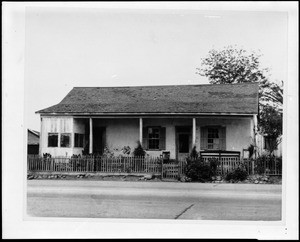 Exterior view of the Juan Avila adobe from across a paved street in San Juan Capistrano, ca.1930