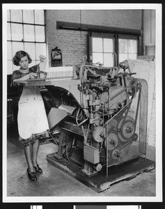 Mary Diack at an automatic book sewing machine for Braille, ca.1933