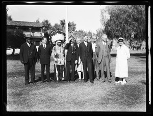 Group of men standing next to a man in Indian dress