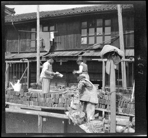 Masons on scaffolding laying brick in China, ca.1900