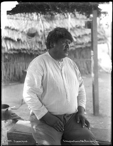 Large Soboba Indian man sitting outside, ca.1900