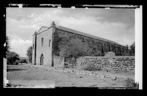 Mission San Gabriel east entrance looking southwest, with an adjoining brick wall, ca.1884