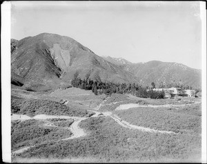 An angled view of Hot Springs Hotel, The Arrowhead, and a web of trails at Lake Arrowhead, 1915