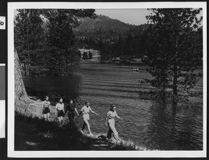 Women hiking by a mountain lake, ca.1940