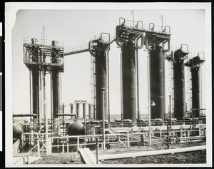 Exterior view of the Shell Oil Company, showing a yard of tall cylinders, ca.1940