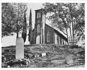 Exterior view of Saint Ann's Church, showing the graveyard, in Columbia