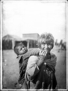 Apache Indian grandmother carrying her grandchild on her back, Palomas Indian Reservation, ca.1900