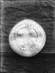 Unidentified coarse-woven Indian basket on display, ca.1900