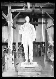 Bronze statue of a man in a factory